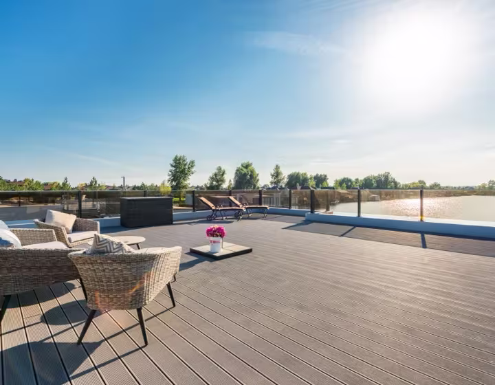 A composite decking board finish with a glass balustrade
